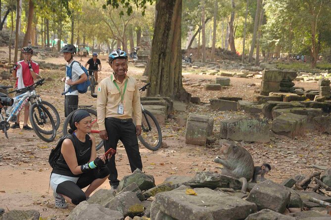 Angkor Sunrise Bike Tour with Lunch Included - Ta Prohm beneath the giant trees