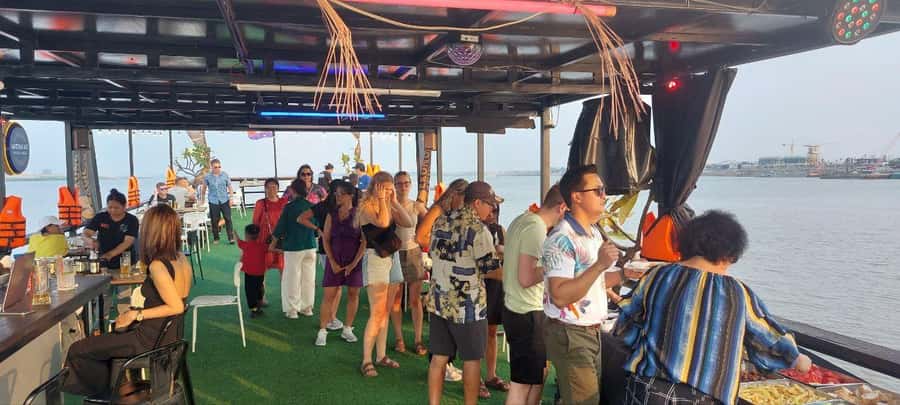 Phnom Penh: Sunset Cruise with Unlimited Beers & BBQ Buffet - Diamond Island bridge and the Cambodian flag